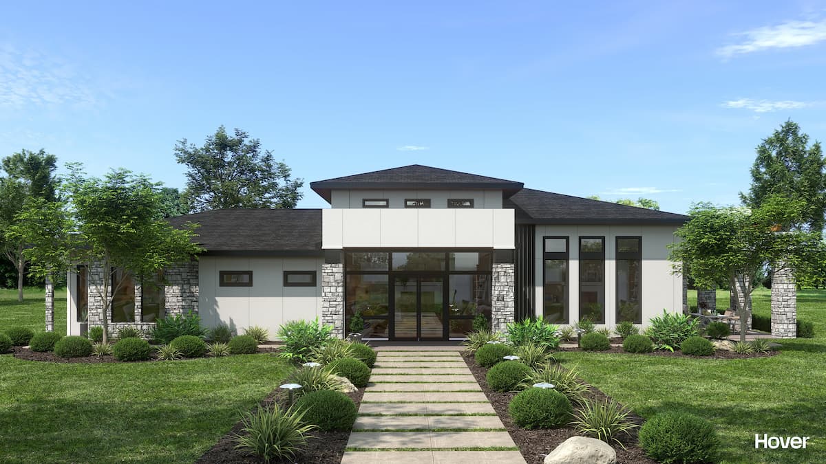 Modern residential home with landscaped yard and lush greenery.