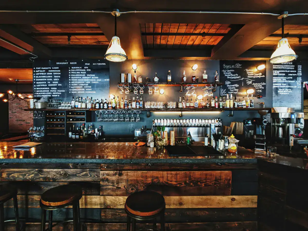 Craft beer bar with a rustic interior and a variety of drinks on display.