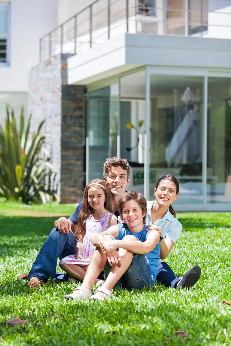 Family enjoying outdoor time on the lawn at Minerva Heights.