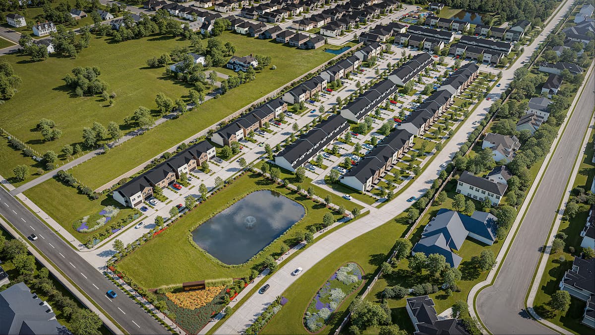 Aerial view of Minerva Heights featuring townhomes, green spaces, and a pond.